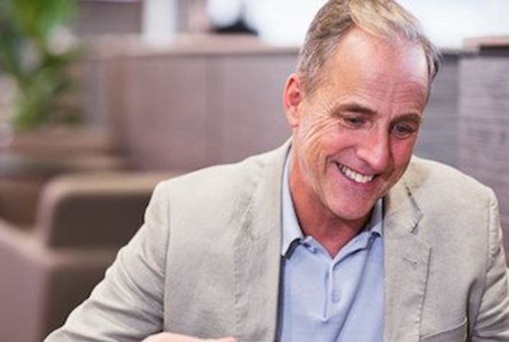 Man drinking coffee in an Aspire Lounge