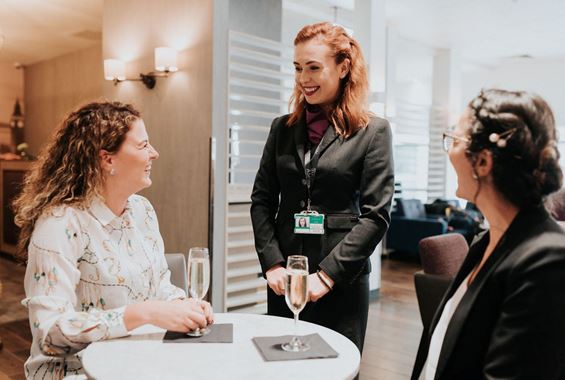 Guests with Drinks at Club Aspire Airport Lounge in London Heathrow Airport Terminal 3